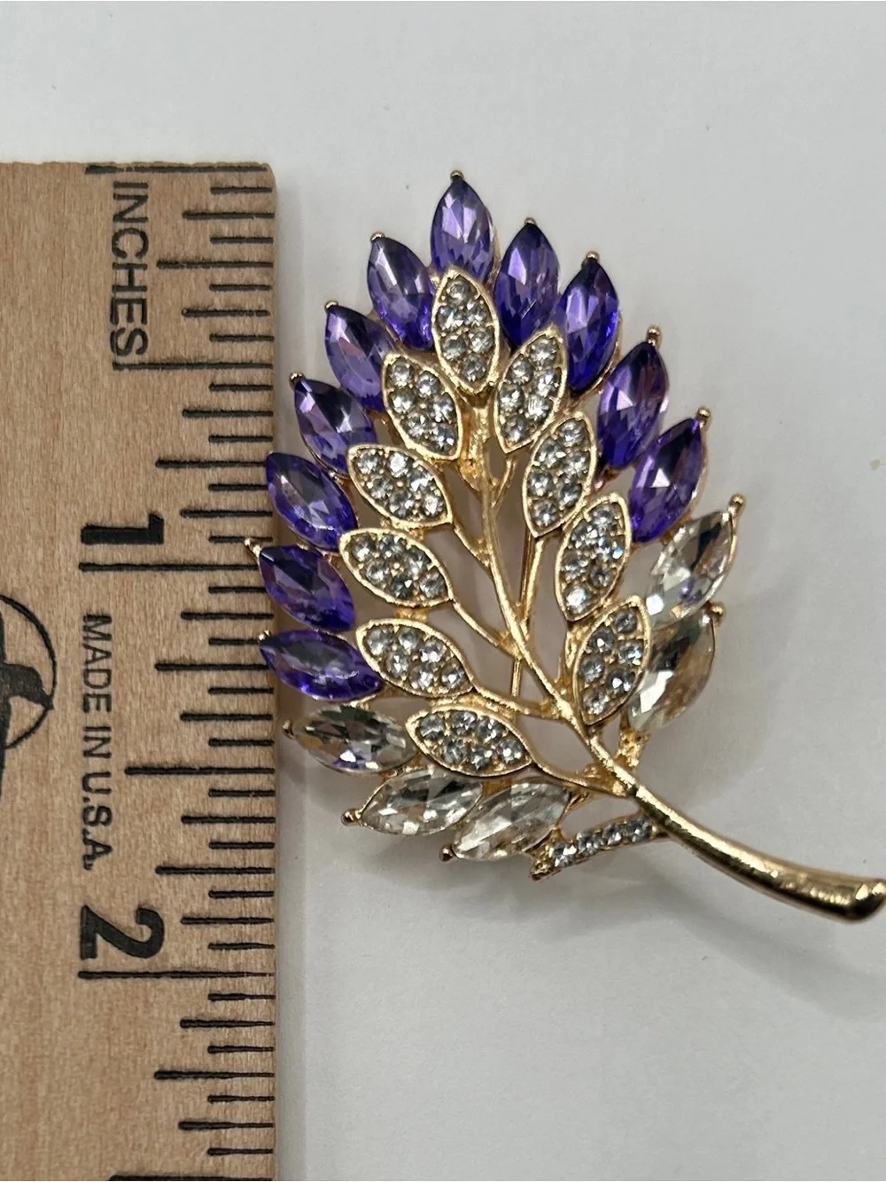 Gold Tone Leaf Brooch with Purple and Clear Faceted Glass Jewels​